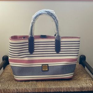 Dooney and Bourke satchel bag. Never used, still has plastic coverings and tags.